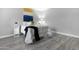 Light and airy bedroom featuring gray walls and vinyl flooring with modern decor and fixtures at 5813 W Gelding Dr, Glendale, AZ 85306