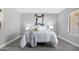 Inviting bedroom features gray walls, modern decor, gray flooring, and a well-lit ambiance at 5813 W Gelding Dr, Glendale, AZ 85306