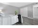 Clean and spacious bedroom featuring white closets and modern gray vinyl flooring at 5813 W Gelding Dr, Glendale, AZ 85306