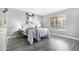 Inviting bedroom features gray walls, modern decor, gray flooring, and a well-lit ambiance at 5813 W Gelding Dr, Glendale, AZ 85306