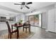 Charming dining area open to the kitchen with gray flooring and a sliding glass door to a private patio at 5813 W Gelding Dr, Glendale, AZ 85306