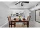 Open dining area next to kitchen, with dark wood table and modern floors at 5813 W Gelding Dr, Glendale, AZ 85306