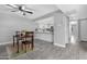 Cozy dining area with dark table, set on rug; open view to kitchen at 5813 W Gelding Dr, Glendale, AZ 85306