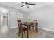 Dining area boasts natural light, modern flooring and view to kitchen at 5813 W Gelding Dr, Glendale, AZ 85306