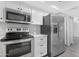 Bright kitchen featuring white cabinetry, stainless steel appliances, and a spacious marble countertop at 5813 W Gelding Dr, Glendale, AZ 85306