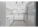Bright kitchen featuring white cabinetry, stainless steel appliances, and a spacious marble countertop at 5813 W Gelding Dr, Glendale, AZ 85306