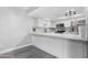 Bright kitchen featuring white cabinetry, stainless steel appliances, and a spacious marble countertop at 5813 W Gelding Dr, Glendale, AZ 85306