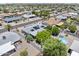 Aerial view of home with solar panels, a pool and lush greenery in a well-maintained neighborhood at 6263 E Duncan St, Mesa, AZ 85205