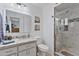 Bathroom featuring white cabinets, marble countertops, and a walk-in shower at 6263 E Duncan St, Mesa, AZ 85205