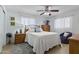 Bright bedroom with a ceiling fan, light walls, and a comfortable seating area at 6263 E Duncan St, Mesa, AZ 85205