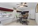 Bright dining area with backyard views, ceiling fan, and tile flooring at 6263 E Duncan St, Mesa, AZ 85205