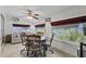 Bright dining area with a ceiling fan and large windows, seamlessly blending indoor and outdoor living spaces at 6263 E Duncan St, Mesa, AZ 85205