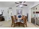 Dining area with wood table and chairs, tile flooring, and view of the screened porch at 6263 E Duncan St, Mesa, AZ 85205