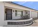Close-up of front porch with seating area, security door and xeriscaping at 6263 E Duncan St, Mesa, AZ 85205