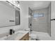 Modern bathroom features a sleek vanity, stylish mirror, tiled shower and black fixtures for a contemporary design at 7137 N 22Nd Dr, Phoenix, AZ 85021