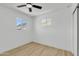 Bright bedroom featuring two windows, a ceiling fan, and modern flooring, showcasing a clean and airy space at 7137 N 22Nd Dr, Phoenix, AZ 85021