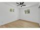 Bright bedroom with a modern ceiling fan, two windows providing plenty of natural light at 7137 N 22Nd Dr, Phoenix, AZ 85021