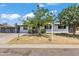 Charming single-story home with a well-maintained front yard and decorative trees under a bright, sunny sky at 7137 N 22Nd Dr, Phoenix, AZ 85021