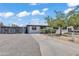 A single story home with an iron security gate and well manicured desert landscaping under a bright sunny sky at 7137 N 22Nd Dr, Phoenix, AZ 85021