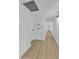 Bright hallway with wood flooring, built-in storage, and modern lighting fixtures at 7137 N 22Nd Dr, Phoenix, AZ 85021
