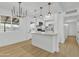 Beautiful living space with views into the upgraded kitchen and featuring updated floors and modern lighting at 7137 N 22Nd Dr, Phoenix, AZ 85021