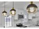 Close up of pendant lighting that illuminates the kitchen bar in the fully remodeled home at 7137 N 22Nd Dr, Phoenix, AZ 85021