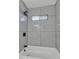 The shower in this bathroom features updated tiling and modern showerhead, highlighting the updated bathroom features at 7137 N 22Nd Dr, Phoenix, AZ 85021