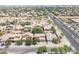 Aerial view of a neighborhood showcasing the houses, tree-lined streets, and landscaping at 9912 W Illini St, Tolleson, AZ 85353
