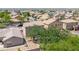 Aerial view of a home's backyard with a playset, trees, and other homes in the neighborhood at 9912 W Illini St, Tolleson, AZ 85353