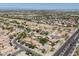 Wide aerial shot of a neighborhood featuring many single-Gathering homes, roads, and desert landscaping at 9912 W Illini St, Tolleson, AZ 85353