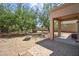 Spacious backyard featuring a covered patio, a fire pit, mature trees, and a playset at 9912 W Illini St, Tolleson, AZ 85353