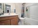 Bathroom with a single vanity, a toilet, a shower-tub combination with a curtain, and tile flooring at 9912 W Illini St, Tolleson, AZ 85353