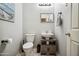 Charming half-bathroom with modern fixtures, vessel sink, decorative mirror, and tiled floor at 9912 W Illini St, Tolleson, AZ 85353