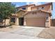 Neutral colored two story home with an attached two-car garage, desert landscaping and tile roof at 9912 W Illini St, Tolleson, AZ 85353