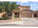 Two story home with a neutral stucco exterior, attached two-car garage and low maintenance desert landscaping at 9912 W Illini St, Tolleson, AZ 85353