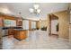 Open kitchen and dining area with stainless steel appliances, large island and tile floors at 9912 W Illini St, Tolleson, AZ 85353