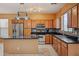 Kitchen featuring stainless steel appliances, a center island with granite countertops, and ample cabinet space at 9912 W Illini St, Tolleson, AZ 85353