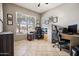Spacious home office features a large window for natural light, neutral walls and tiled flooring at 9912 W Illini St, Tolleson, AZ 85353