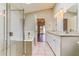 Well-lit bathroom boasts double sinks, a skylight, and a glass-enclosed shower and tub at 1048 N Arroya --, Mesa, AZ 85205