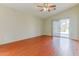 Bedroom with wood floors, sliding glass doors to patio and ceiling fan at 1048 N Arroya --, Mesa, AZ 85205