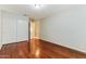 Clean bedroom with wood floors, a closet, and access to the rest of the home at 1048 N Arroya --, Mesa, AZ 85205