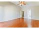 Spacious bedroom with a ceiling fan and wood floors, leading to the bathroom and closet at 1048 N Arroya --, Mesa, AZ 85205