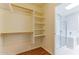 Organized closet with built-in shelving, adjacent to a bathroom with glass shower enclosure at 1048 N Arroya --, Mesa, AZ 85205