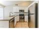 Well-equipped kitchen with stainless steel appliances, granite countertops, and white cabinets at 1048 N Arroya --, Mesa, AZ 85205