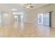 Bright living area with tile floors, ceiling fan, and sliding glass door to the patio at 1048 N Arroya --, Mesa, AZ 85205