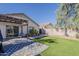 Spacious backyard with artificial grass, paved patio area, covered patio and privacy fence at 11101 E Abilene Ave, Mesa, AZ 85208