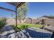 Landscaped backyard featuring synthetic lawn, brick paver patio, privacy wall and shade tree at 11101 E Abilene Ave, Mesa, AZ 85208