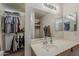 Bathroom featuring a single sink vanity and a walk-in closet at 11101 E Abilene Ave, Mesa, AZ 85208