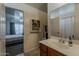 Bathroom featuring single sink vanity with an adjacent bedroom and closet at 11101 E Abilene Ave, Mesa, AZ 85208