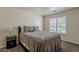 Comfortable bedroom with a plush bed, window with blinds and stylish nightstand with contemporary design at 11101 E Abilene Ave, Mesa, AZ 85208